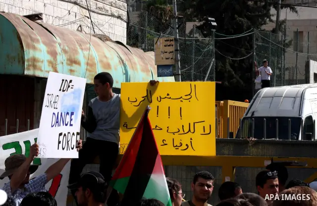 Israeli, foreign and Palestinians activists protest against the building of Jewish settlement and against the Jewish settlers living in the Palestinian territories, as they gather at the Israeli manned Beit Romano settle...