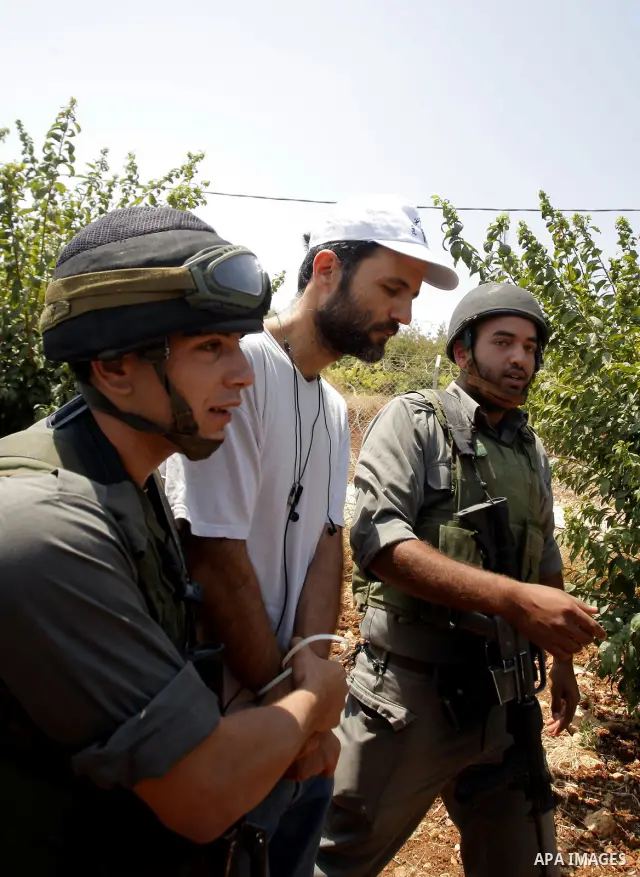 Israeli troops arrest a protester during a demonstration in Beit Omar village, north of Hebron, on July 10, 2010 against Israel's controversial separation barrier and the expansion of nearby Jewish settlements in the occ...