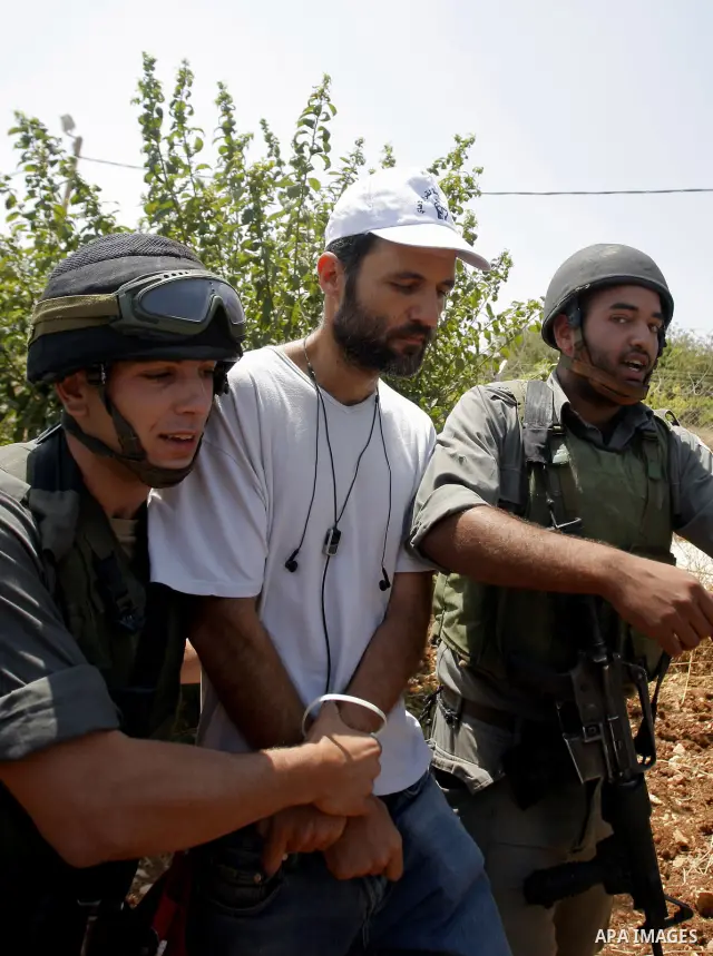 Israeli troops arrest a protester during a demonstration in Beit Omar village, north of Hebron, on July 10, 2010 against Israel's controversial separation barrier and the expansion of nearby Jewish settlements in the occ...