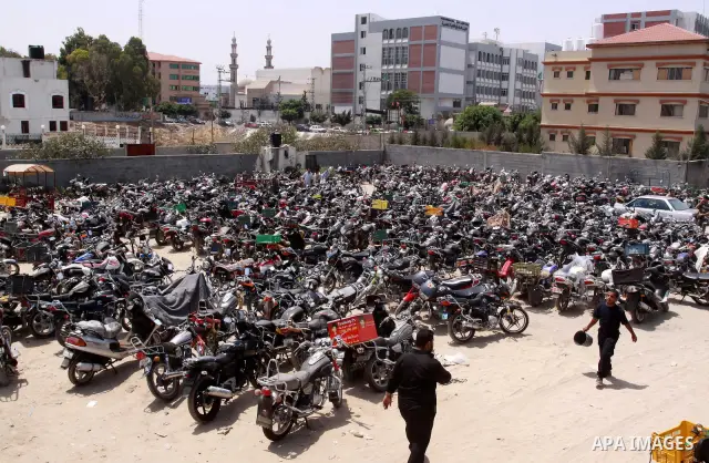 Palestinian members of the ministry of transport and traffic police destroy a large numbers of unlicensed motorcycles in Gaza city on July 13,2010. Photo by Mohammed Asad