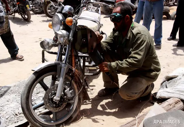 Palestinian members of the ministry of transport and traffic police destroy a large numbers of unlicensed motorcycles in Gaza city on July 13,2010. Photo by Mohammed Asad