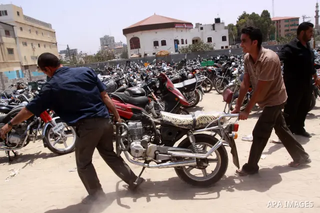 Palestinian members of the ministry of transport and traffic police destroy a large number of unlicensed motorcycles in Gaza city on July 13,2010. Photo by Mohammed Asad