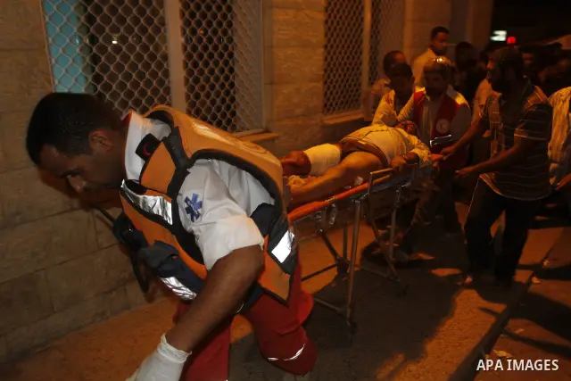 A wounded Palestinian man is rushed to a hospital after Israeli shelling in the central Gaza Strip July 13, 2010. Israeli army shelling killed a Palestinian woman and wounded two of her relatives in the central Gaza Stri...
