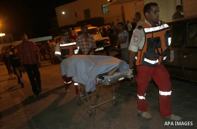 Palestinian medical workers wheel the body of Nema Abu Said, 46 to the morgue of al-Aqsa hospital after Israeli shelling in the central Gaza Strip July 13, 2010. Israeli army shelling killed a Palestinian woman and wound...