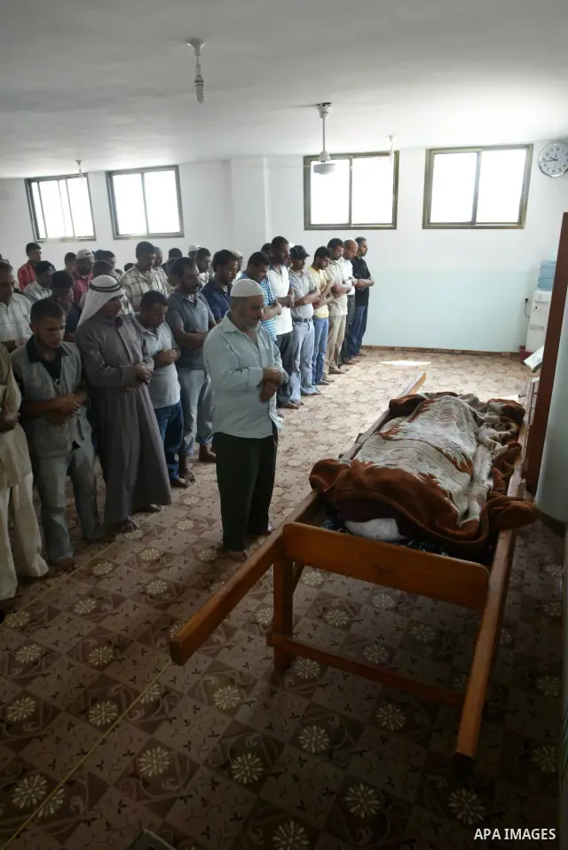 Mourners pray in front of the body of Palestinian woman Nema Abu Said during her funeral in the village of Johar a-Deek in the central Gaza Strip July 14, 2010. Israeli army shelling killed Abu Said and wounded two of he...