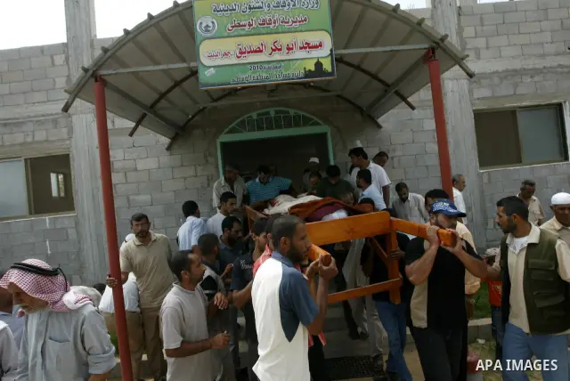 Mourners carry the body of Palestinian woman Nema Abu Said during her funeral in the village of Johar a-Deek in the central Gaza Strip July 14, 2010. Israeli army shelling killed Abu Said and wounded two of her relatives...
