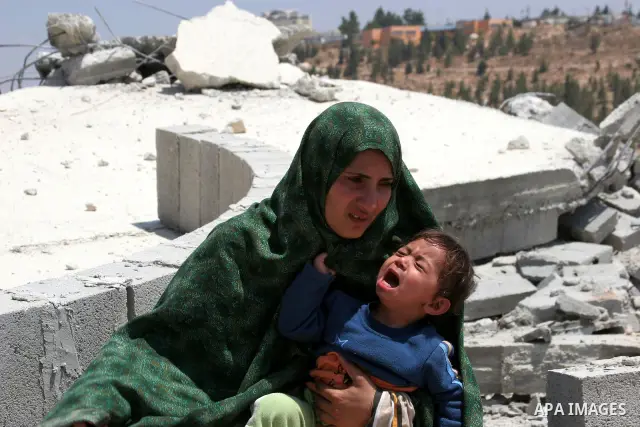 Palestinians inspect a demolished house in the village of Al-Samoua near the West Bank city of Hebron on July 15 2010. The Israeli government claimed that the houses that were demolished were not licensed, but the homeow...