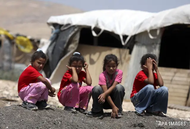 Palestinian Bedouin children play near their tents on the road between Jericho and Ramallah on July 15, 2010 as Palestinian bedouins live hard life in the West Bank. Photo by Eyad Jadallah