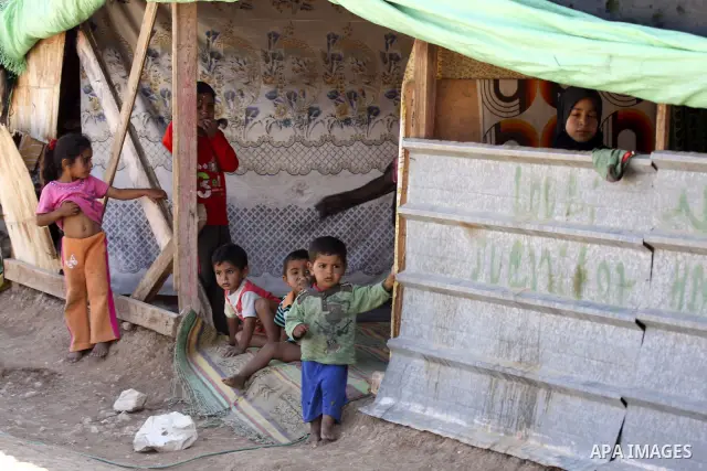 Palestinian Bedouin children play near their tents on the road between Jericho and Ramallah on July 15, 2010 as Palestinian bedouins live hard life in the West Bank. Photo by Eyad Jadallah