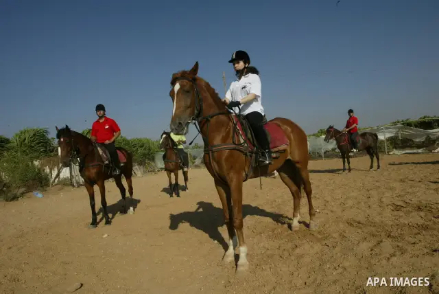 Palestinians ride horses during the "Jump Championship" local race in Gaza City July 15, 2010. Photo by Ashraf Amra