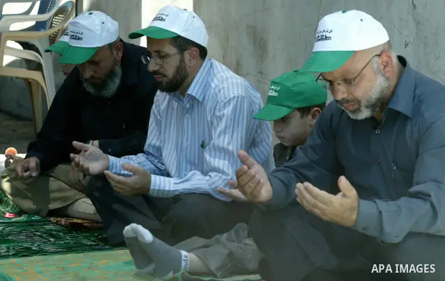 Palestinians pray in the Red Cross yard during the Friday prayer in East Jerusalem , Friday 16 July 2010, in solidarity with PLC members and former Palestinian minister Ahmad Atwon, Mohammad Totah and Khalid Abu Arfeh. A...