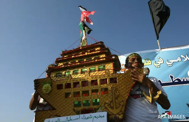 Palestinian supporters of Islamic Jihad movement hold a rally in solidarity with the nine Turkish activists who were killed aboard Gaza-bound aid flotilla in May after Israeli navy stormed it, at Gaza seaport in Gaza cit...