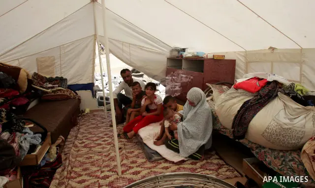 Palestinian family sit in a tent on the rubbles of their home in the Arab neighborhood of Beit Hanina in occupied east Jerusalem on July 17,2010 after Israeli army bulldozers destroyed their home. Al Rajabi family which...