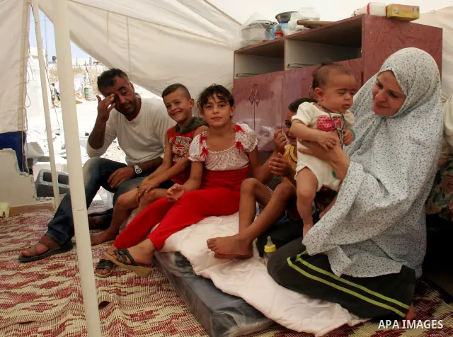 Palestinian family sit in a tent on the rubbles of their home in the Arab neighborhood of Beit Hanina in occupied east Jerusalem on July 17,2010 after Israeli army bulldozers destroyed their home. Al Rajabi family which...