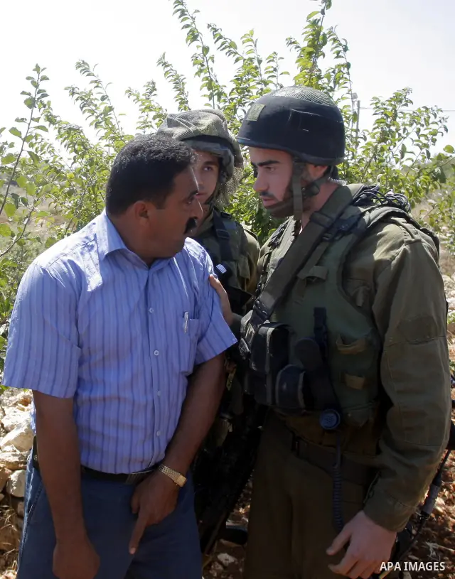 Israeli soldiers try to disperse foreign activists protesting against a nearby Israeli settlement near the West Bank village of Beit Omar July 17, 2010. Photo by Mamoun Wazwaz