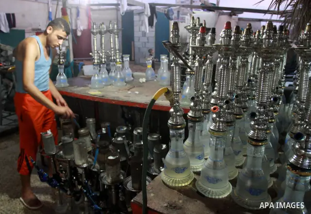 A Palestinian worker makes ready flavoured tobacco water pipes or 'shisha' prior to the evening influx of customers in Gaza City on July 17, 2010, as the ruling Islamic Hamas party tries to impose a ban on smoking water...