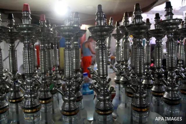 A Palestinian worker makes ready flavoured tobacco water pipes or 'shisha' prior to the evening influx of customers in Gaza City on July 17, 2010, as the ruling Islamic Hamas party tries to impose a ban on smoking water...