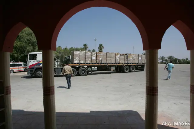 A convoy carrying medical aid which was shipped in on a Libyan aid ship to an Egyptian port crosses to the Palestinian Gaza Strip through the Rafah border between Egypt and southern Gaza Strip, on July 18, 2010. The Liby...