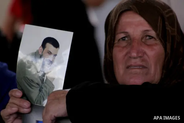Palestinian women and children hold pictures of jailed relatives during a protest calling for the release of Palestinian prisoners from Israeli jails at the Red Cross office in Gaza City on July 19,2010. Photo by Yousef...