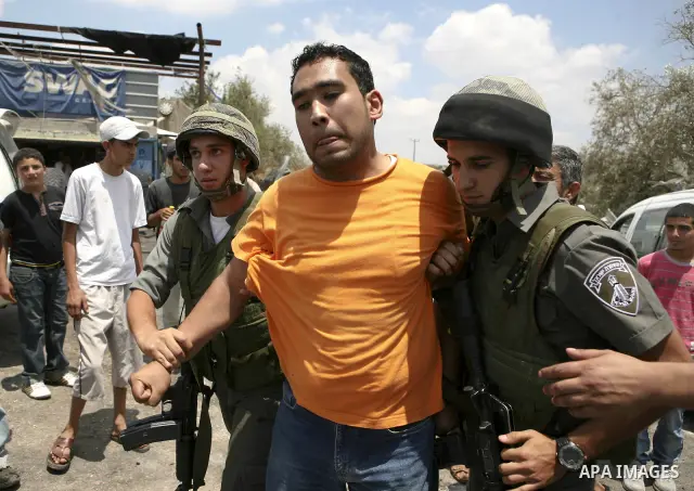 Israeli soldiers detain a Palestinian villager following clashes in the West Bank village of Lubban al-Gharbia on July 21, 2010 after Israeli forces demolished two houses and four shops that were built without the army's...