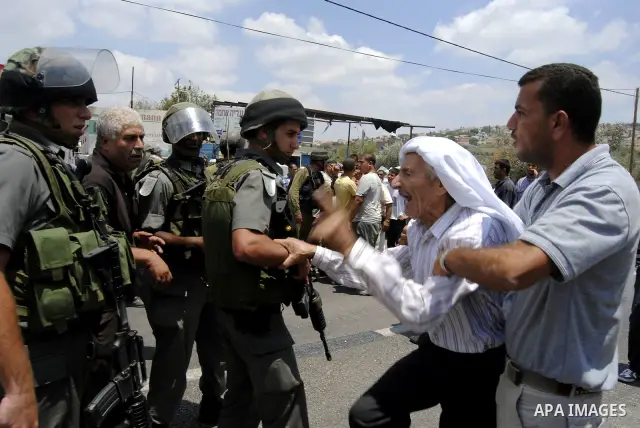 Palestinians scuffle with Israeli soldiers in the West Bank village of Lubban al-Gharbia on July 21, 2010 after Israeli forces demolished two houses and four shops that were built without the army's permit near a road le...