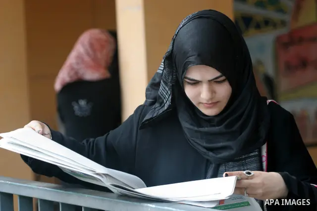 A Palestinian secondary school student reads a local newspaper to find his result in Gaza city on July 22,2010. The Ministry of Education in Gaza Strip and the West Bank announced the results together. Photo by Mohammed...