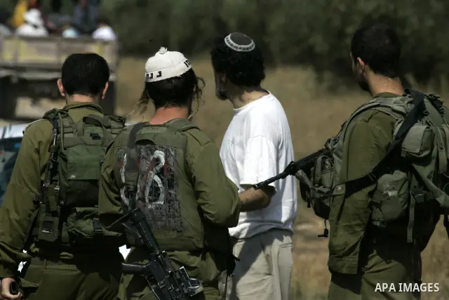 Israeli soldiers prevent Israeli activists from entering the village of Awarta in order to help Palestinian farmers to plant olive trees near the West Bank city of of Nablus, Thursday, July, 22, 2010. Israel's military s...