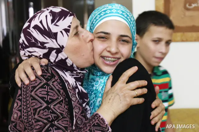 A Palestinian student from the top ten in the general secondary certificate in Palestine, Nour Tamim, 99.1, is greeted by her family in the West Bank city of Nablus on July 22,2010. Photo by Wagdi Eshtayah