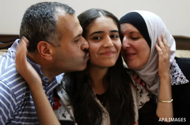A Palestinian student from the top ten in the general secondary certificate in Palestine, Eiman Aljian, 99.5, is greeted by her family in the West Bank city of Nablus on July 22,2010. Photo by Wagdi Eshtayah