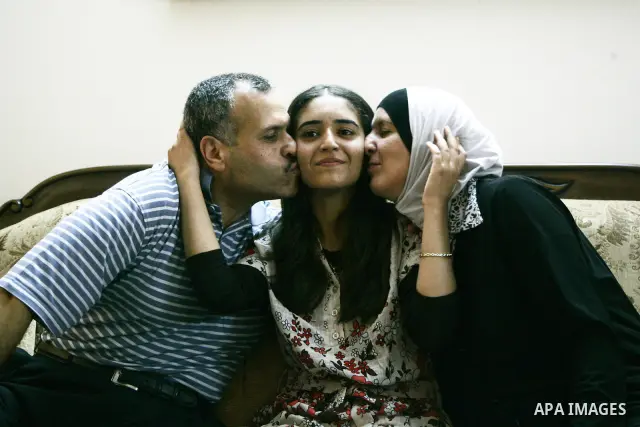 A Palestinian student from the top ten in the general secondary certificate in Palestine, Eiman Aljian, 99.5, is greeted by her family in the West Bank city of Nablus on July 22,2010. Photo by Wagdi Eshtayah