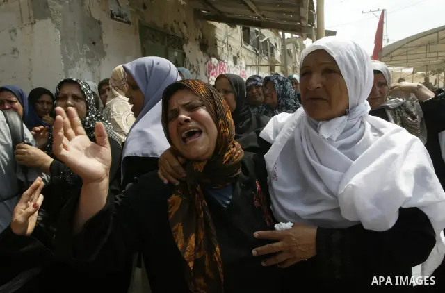 Palestinian relatives of Qassim al-Shinbari, a militant from the Popular Front for the Liberation of Palestine (PFLP), mourn during his funeral in the town of Beit Hanoun in northern Gaza Strip July 22, 2010. Israeli she...
