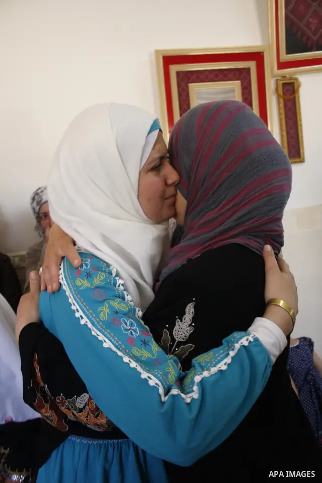 A Palestinian student from the top ten in the general secondary certificate in Palestine, Saja Al-Khadour, 99.5, is greeted by her family in the West Bank city of Hebron on July 22,2010. Photo by Mamoun Wazwaz