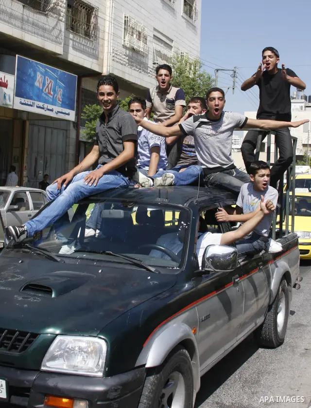 Palestinian students celebrate after her success in the general secondary certificate in the West Bank city of Hebron on July 22,2010. Photo by Mamoun Wazwaz