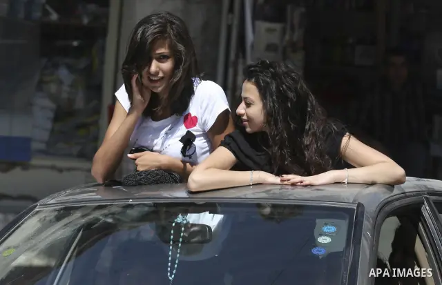 Palestinian general secondary students celebrate after their success in the exams results in the West Bank city of Ramallah on July 22, 2010. Photo by Eyad Jadallah
