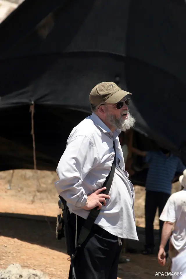 Armed Jewish ideological settlers set up tents on Palestinian land as they try to establish a new outpost near the Israeli settlement of Kharsina on 23 July 2010 east of Hebron, in the occupied West Bank. Photo by Mamoun...