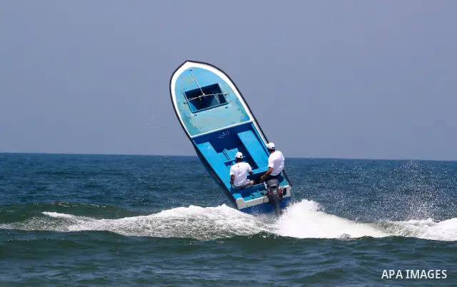 Palestinian men ride their boats during a race near Gaza seaport on July 26,2010. Palestinians participate in the boats race for the first time in Gaza Strip. Photo by Mohammed Asad