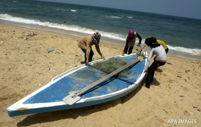 Madlin, her brother Kayed and sister Reem , take their small boat to fish off the coast of Gaza City on July 25, 2010. Madlin is the first girl in the Gaza Strip to fish professionally in order to support her poor family...