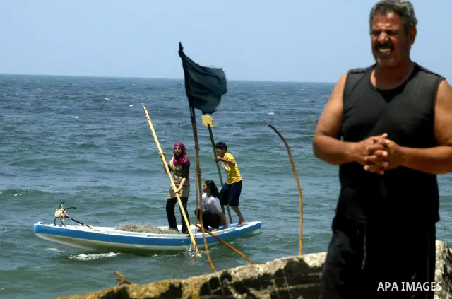 Madlin, her brother Kayed and sister Reem , take their small boat to fish off the coast of Gaza City on July 25, 2010. Madlin is the first girl in the Gaza Strip to fish professionally in order to support her poor family...
