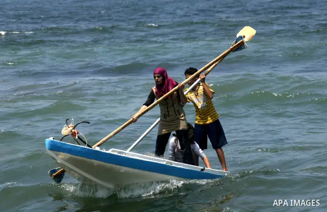 Madlin, her brother Kayed and sister Reem , take their small boat to fish off the coast of Gaza City on July 25, 2010. Madlin is the first girl in the Gaza Strip to fish professionally in order to support her poor family...