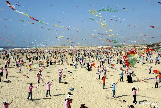 Palestinian children fly kites along the beach during a U.N. run summer camp in Gaza City on July 29, 2010. Thousands of children in the Gaza Strip gathered to break the world record for kite flying for the second time....