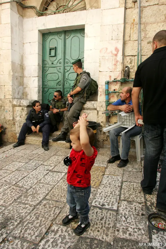 Palestinians gather past at house in Jerusalem's Old City that was taken over by Israeli settlers backed by police on July 29, 2010 resulting in the expulsion of a large Palestinian family that had lived there for more t...