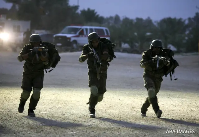 Members of the Palestinian security forces demonstrate their skills during a graduation ceremony in the West Bank city of Jericho, July 31, 2010. Photo by Eyad Jadallah