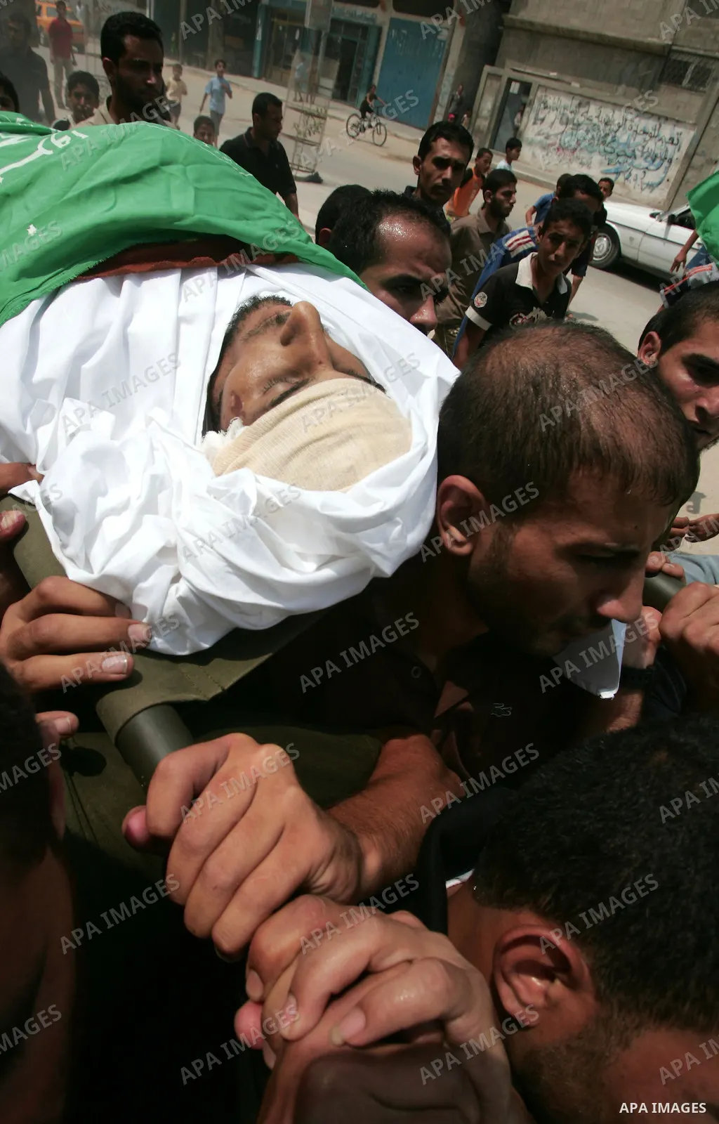 Palestinian mourners carry the body of Hamas militant Shareef Qudeir, 22, during his funeral in KhanYounis refugee camp, southern Gaza Strip, Wednesday, Aug. 4, 2010. A Palestinian health official said Wednesday that a G...