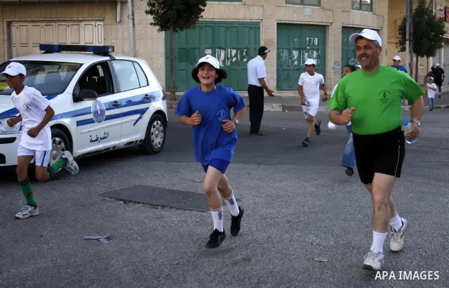 Palestinians run during the marathon in the West Bank city of Hebron on August 6,2010 . Photo by Mamoun Wazwaz