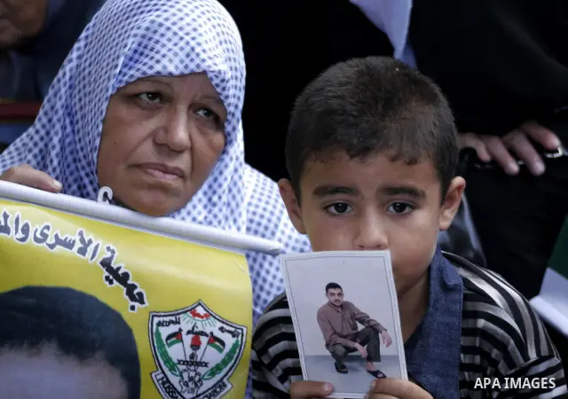 Palestinian women and children hold pictures of jailed relatives during a protest calling for the release of Palestinian prisoners from Israeli jails at the Red Cross office in Gaza City on August 9,2010. Photo by Yousef...