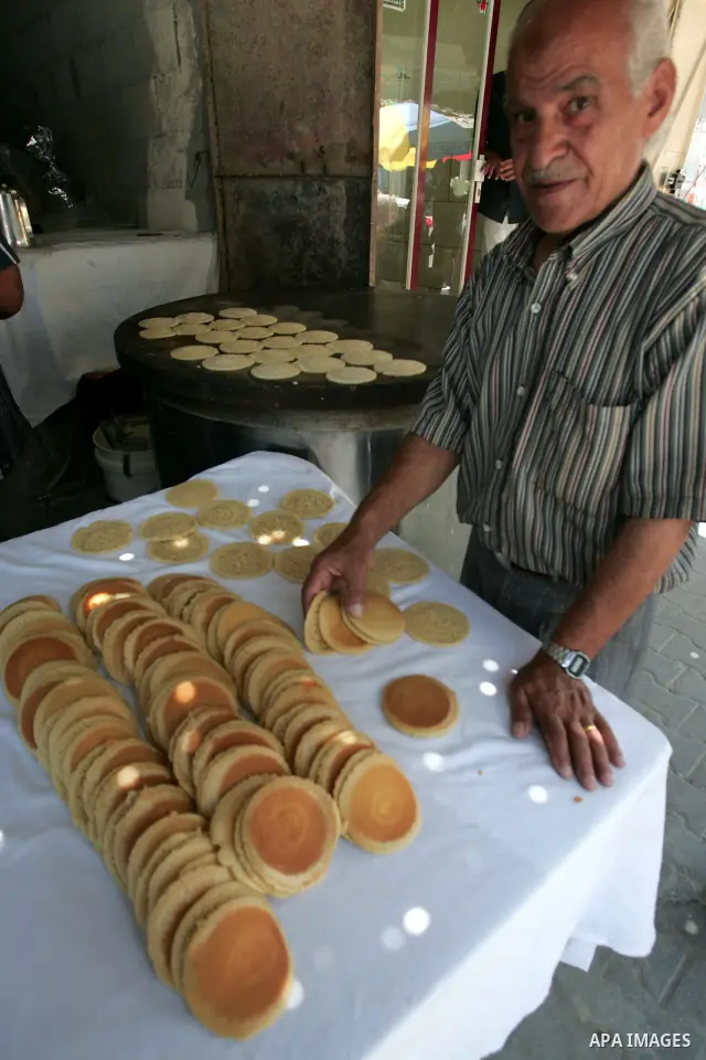 A Palestinian baker makes small traditional pancakes on the first day of the holy month of Ramadan in Rafah in the southern Gaza Strip on August 11,2010. Muslims all over the world fast from dawn to dusk during the holy...