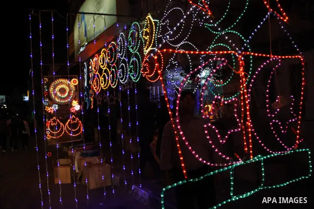Palestinian Muslims decorate the street with festive lights in the celebration for the Muslim holy month of Ramadan in the West Bank city of Hebron on August 12,2010. Ramadan is the ninth month of the Islamic calendar, a...