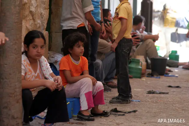 Palestinians receive donated food from an Islamic charity on the fourth day of the Muslim holy month of Ramadan, in the West Bank city of Hebron, Saturday, August 14, 2010. Devout Muslims refrain from eating, drinking an...