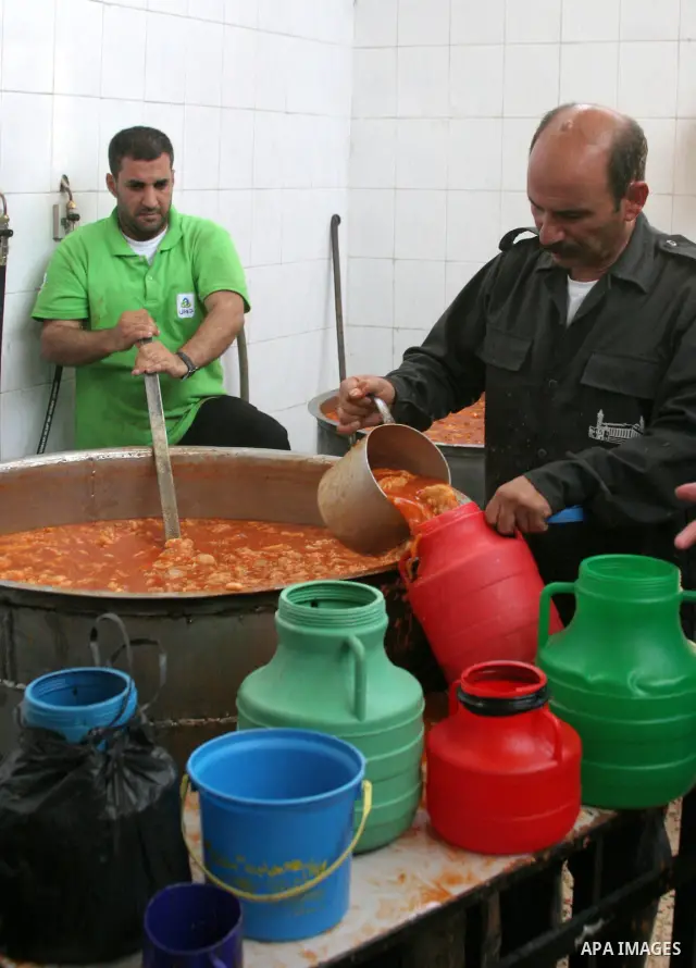 Palestinians receive donated food from an Islamic charity on the fourth day of the Muslim holy month of Ramadan, in the West Bank city of Hebron, Saturday, August 14, 2010. Devout Muslims refrain from eating, drinking an...