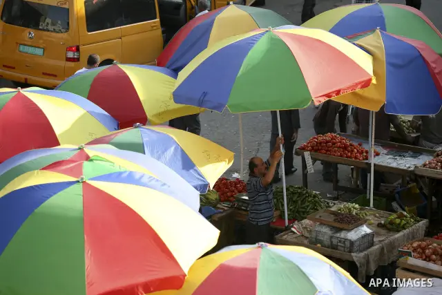 Umbrellas shade Palestinians as they shop at a traditional market on the fifth day of the holy month of Ramadan in the West Bank city of Ramallah on August 15,2010. Devout Muslims refrain from eating, drinking and smokin...